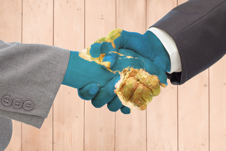 Handshake between two business people against wooden planksの写真素材