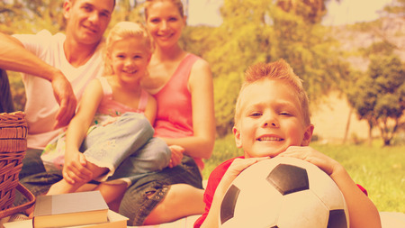 Little boy having fun with a soccer ball with his family smilingの写真素材
