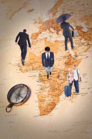 Smiling older couple going on their holidays against world map with compass showing africaの写真素材