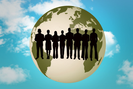 Silhouette of business people in a row against blue skyの写真素材