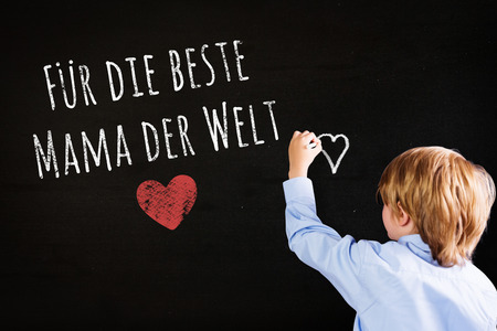 Cute pupil writing against blackの写真素材