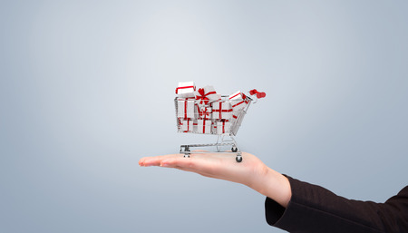 Businesswomans arm presenting against grey vignetteの写真素材