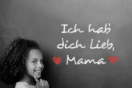 German mothers day message against schoolchild with blackboardの写真素材
