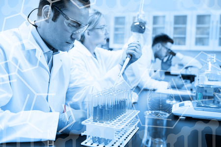 Science graphic against science student using pipette in the lab to fill test tubes