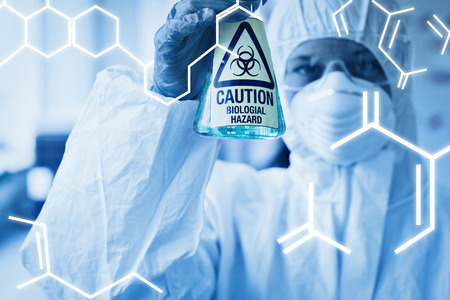 Science graphic against scientist in protective suit with hazardous chemical in flaskの写真素材
