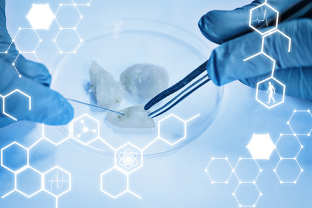 Science graphic against food scientist dissecting raw chicken