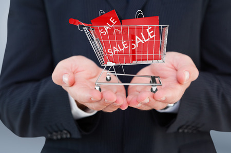 Close up of hand of a businessman  against grey vignetteの写真素材