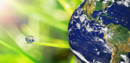 earth against dew on the grass close upの写真素材