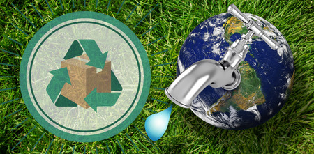 Earth with faucet against grass background