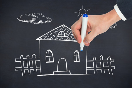 Hand writing with a marker against black backgroundの写真素材