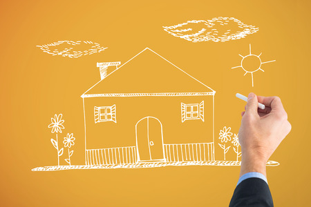 Hand writing with a white chalk against yellowの写真素材