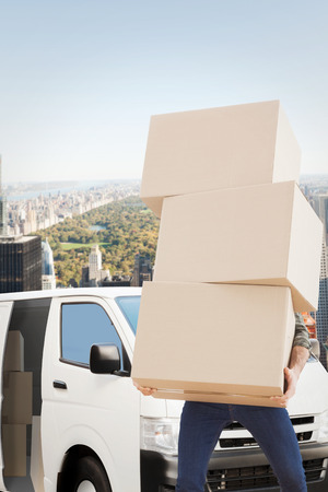 Man carrying pile of boxes against new yorkの写真素材