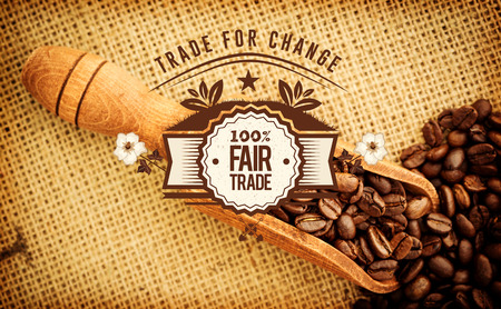 Fair Trade graphic against wooden shovel full of coffee beansの写真素材