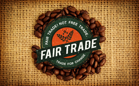 Fair Trade graphic against coffee beans formed into shapeの写真素材