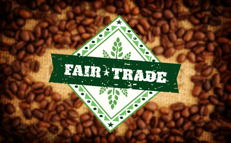 Fair Trade graphic against coffee beans surrounding coffee stamp on sackの写真素材