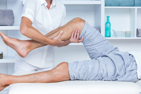 Man having leg massage in medical officeの写真素材