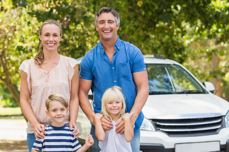 Happy family getting ready for road trip on a sunny dayの写真素材