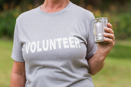Volunteer holding tin can on a sunny dayの写真素材