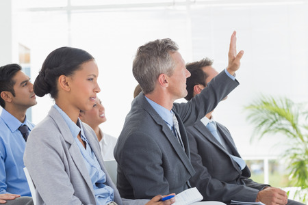 Businessman asking question during meeting in officeの写真素材