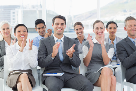 Business people applauding during meeting in office Business people applauding during meeting in office