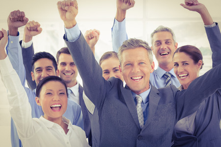 Business people cheering in office on white backgroundの写真素材