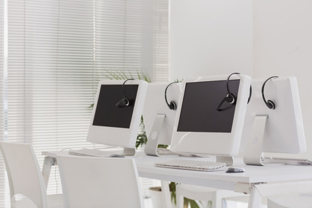 Computers and headsets in empty office