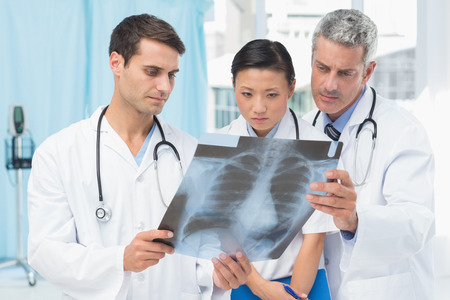 Male and female doctors examining x-ray in the medical officeの写真素材