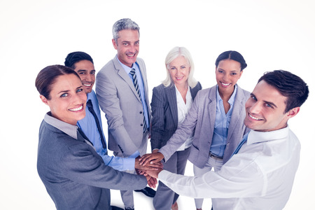 Executives holding hands together in office