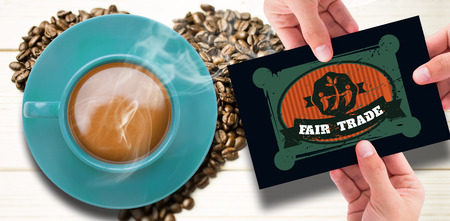 Hand showing card against coffee beans in heart shapeの写真素材