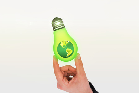 Businessman measuring something with his fingers against earth