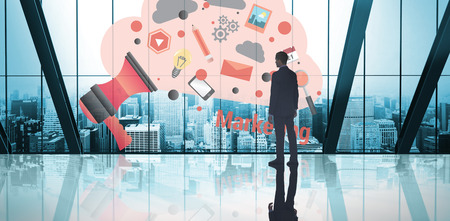Businessman standing against room with large window looking on city Businessman standing against room with large window looking on city