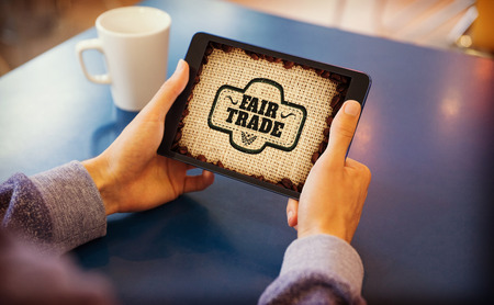 Man using tablet pc against fair tradeの写真素材