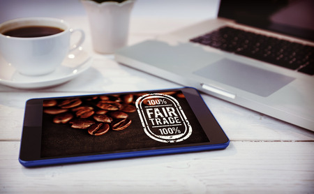 Fair Trade against desk with laptop and tabletの写真素材