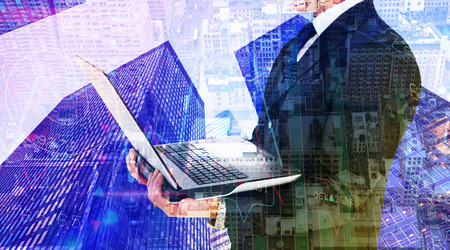 Businessman with watch using tablet pc against new yorkの写真素材