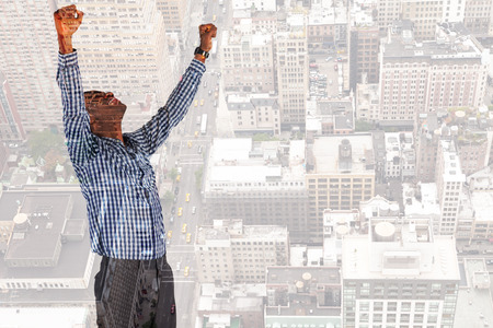 Excited businessman cheering against new yorkの写真素材