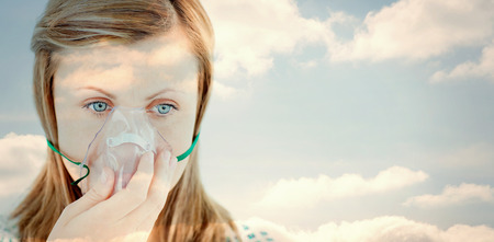 Cloudy sky against diseased young woman wearing a maskの写真素材