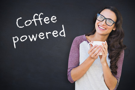 Brunette with mug against black backgroundの写真素材