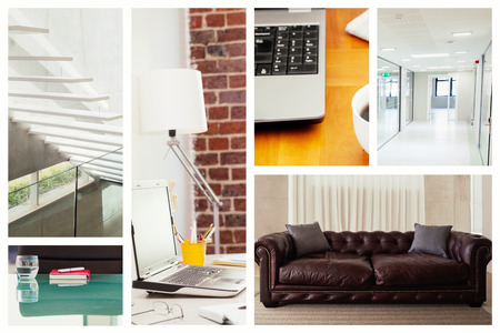 Laptop on desk with glasses and notepad against brown leather couch in a modern living roomの写真素材