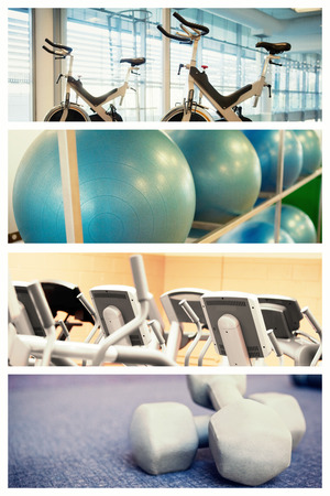 Spin bikes in fitness studio against exercise balls on rack in studioの写真素材
