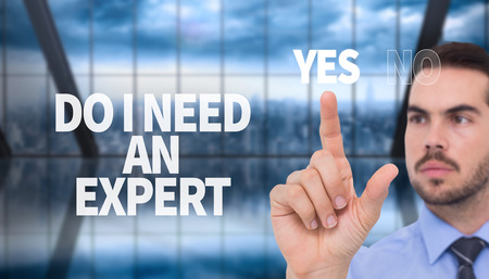 Businessman measuring something with his fingers against room with large window looking on cityの写真素材