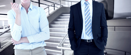 Smiling businesswoman looking at camera against empty stair wayの写真素材