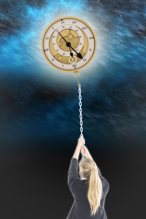 Businesswoman pulling a chain against aurora night sky in blueの写真素材