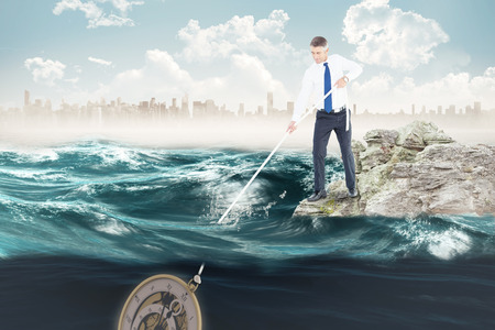 Businessman pulling rope against cityscape on horizon over oceanの写真素材