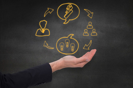 Close up of businessman with empty hand open against black wallの写真素材