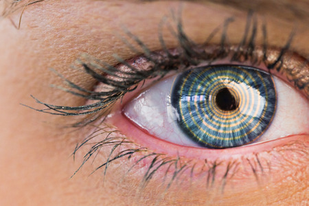 Close up of female blue eye against spiralの写真素材