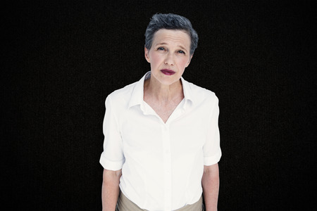 Serious businesswoman against black backgroundの写真素材