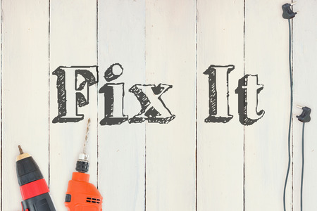 The word fix it against diy tools on wooden backgroundの写真素材