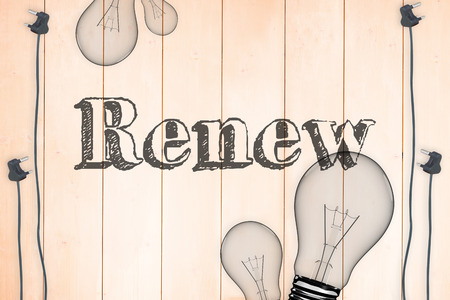 The word renew against light bulb on wooden backgroundの写真素材