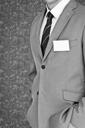 Businessman with badge against grey backgroundの写真素材