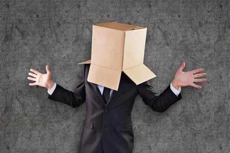 Anonymous businessman with hands out against grey background